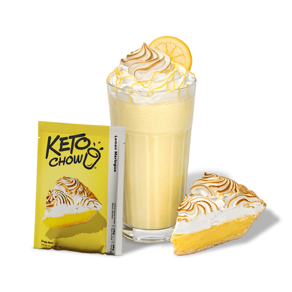 KETO CHOW Lemon Meringue meal shake. Yellow single-serving packet with a pie image, text Lemon Meringue, Single Meal, Net Wt 1.4 oz (40g). Pictured with a glass of yellow shake topped with whipped cream, lemon slice, and a lemon meringue pie slice.