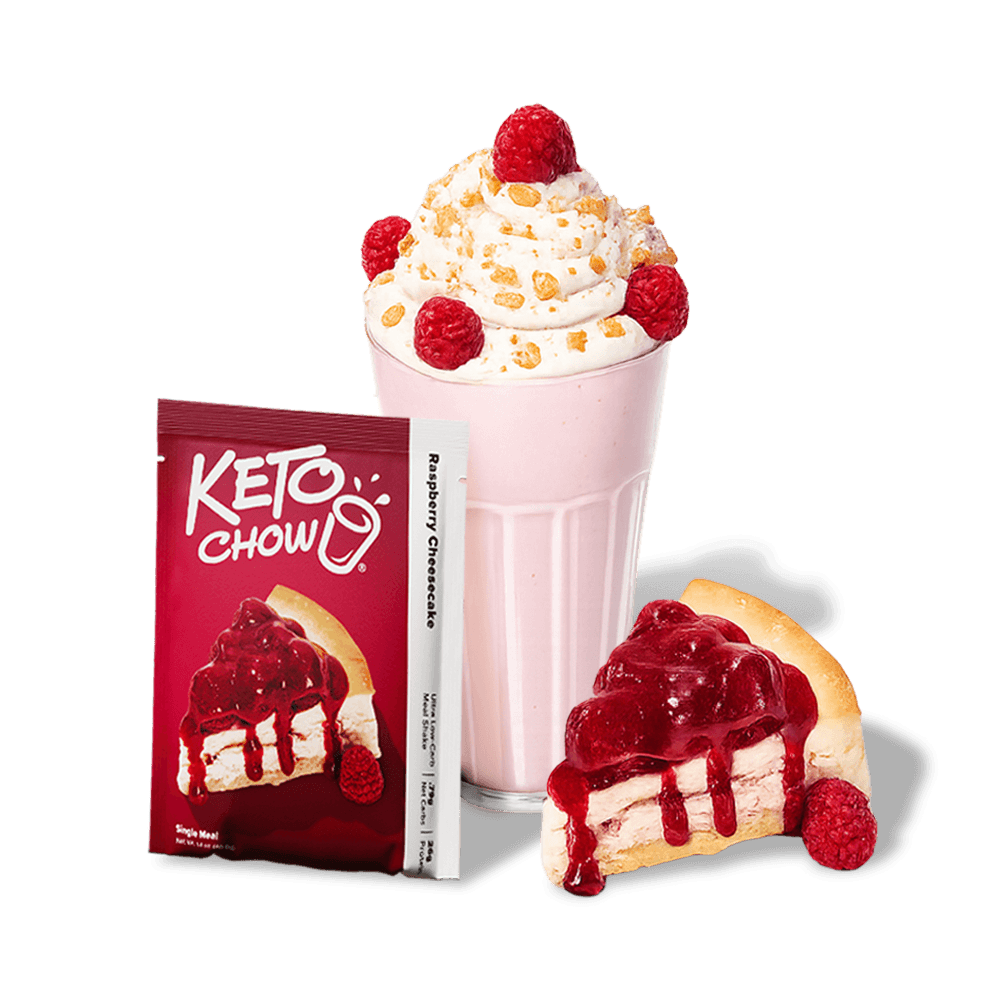 KETO CHOW Raspberry Cheesecake red packet displays logo, cheesecake image, Single Meal text. A white stick packet. Pink milkshake with whipped cream, sprinkles, raspberries. Cheesecake slice with raspberry topping and a whole raspberry.