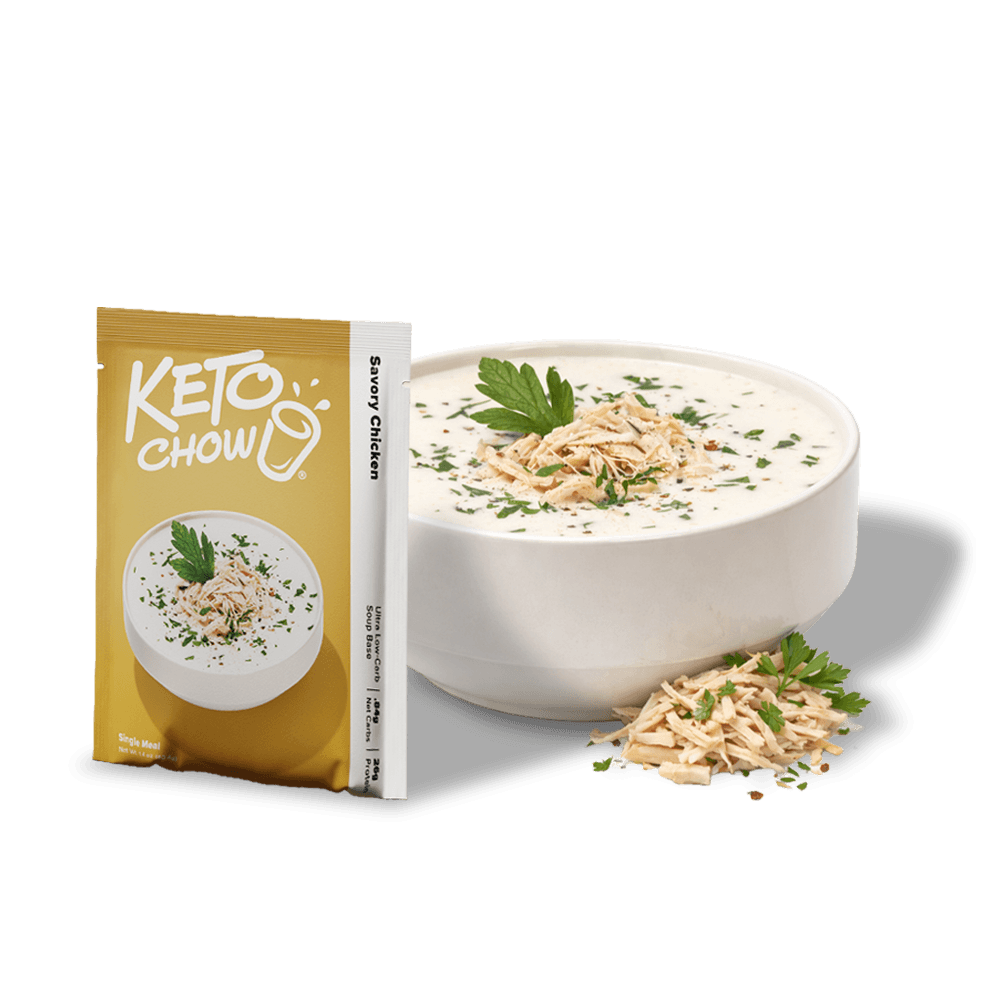 KETO CHOW Savory Chicken Ultra Low-Carb Soup Base single meal packet in golden yellow and white, next to a white bowl of soup with chicken and parsley.