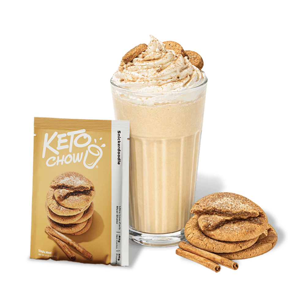 KETO CHOW Snickerdoodle meal shake pouch. A snickerdoodle shake in a glass with whipped cream and cookies, plus cookies and cinnamon sticks on the side.